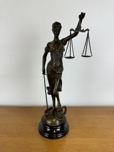 Bronzová socha lady justice na mramorovém podstavci